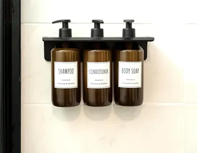 three bottles on a shelf in a bathroom at Bianca Guest House in Rome