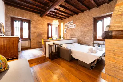 a bedroom with a large bed in a brick wall at Pantheon Private Apartment in Rome