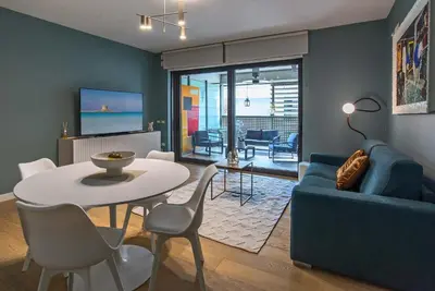 a living room with a table and a blue couch at Albertahaus in Rome