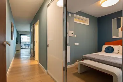 a small bedroom with a bed and a hallway at Albertahaus in Rome