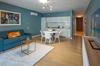 a living room with a blue couch and a table at Albertahaus in Rome