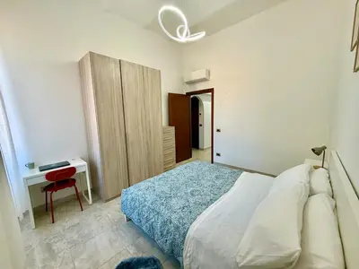 a bedroom with a bed and a desk with a chair at SanLo Nest in Rome