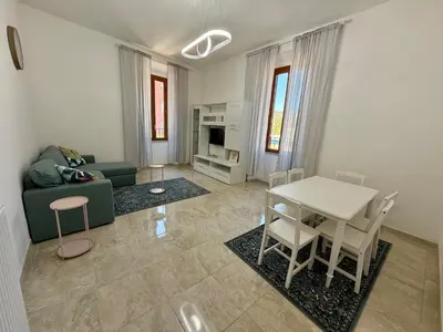 a living room with a couch and a table and chairs at SanLo Nest in Rome