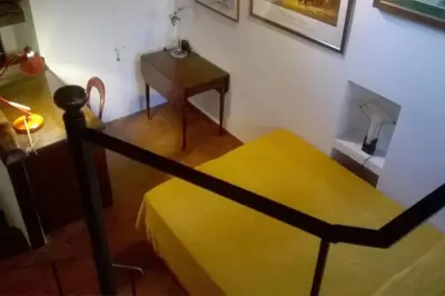 a room with a yellow bench and a table at Laurina 4 - LOCAPPART in Rome