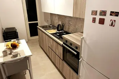 a kitchen with a white refrigerator and a counter at Casa Amorello - Vaticano in Rome