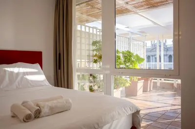a bedroom with a bed and a large window at San Giovanni Rooftop in Rome