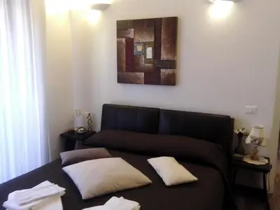 a bed with two pillows on it in a room at Appartamento Cuore Antico in Rome