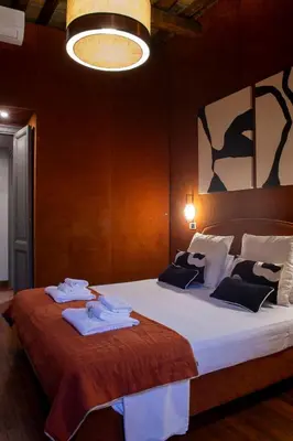 a bedroom with a large bed with towels on it at Pantheon Deluxe in Rome