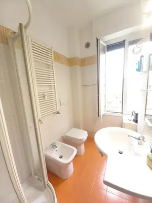 a white bathroom with a toilet and a sink at Rome center near Colosseum and metro a in Rome