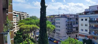a tall tree in a city with buildings at La Casetta Di Nonna Anna - 120 mq Bright Apartment in Rome in Rome