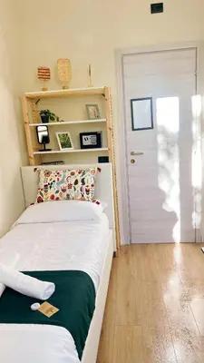 a bedroom with a bed and a white door at Laterano's House in Rome