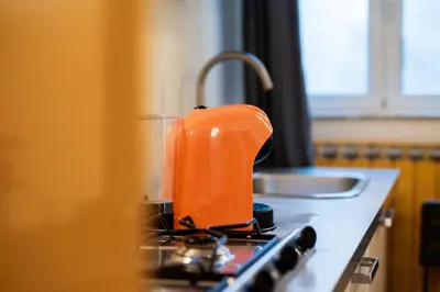 an orange item is sitting on top of a stove at Campo De Fiori Apartments in Rome