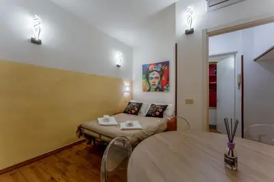 a room with a bed and a table in it at Campo De Fiori Apartments in Rome