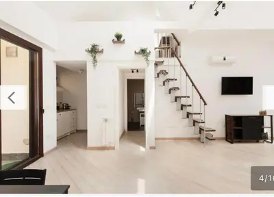 an open living room with a staircase in a house at Trastevere City Life Apartments in Rome