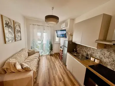 a living room with a couch and a kitchen at Domus Antea in Rome