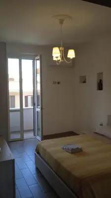 a bedroom with a bed and a chandelier at Danielas House in Rome