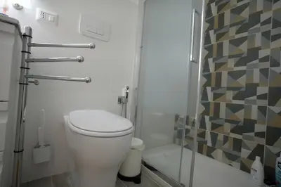 a bathroom with a toilet and a glass shower at Camera con bagno in posizione strategica in Rome