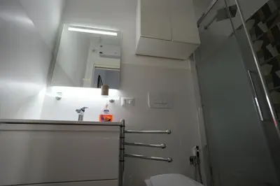 a bathroom with a toilet and a sink and a mirror at Camera con bagno in posizione strategica in Rome