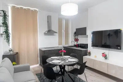a kitchen and living room with a table and chairs at LUXURY BABUINO -exclusive apartment in Rome