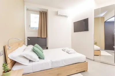 a bedroom with a bed with a mirror and a television at Vatican Museums Stay with Terrace in Rome