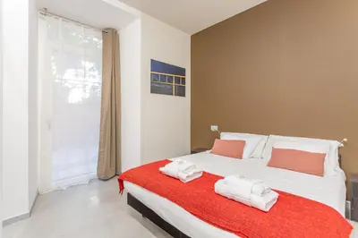 a bedroom with a large bed with towels on it at Vatican Museums Stay with Terrace in Rome