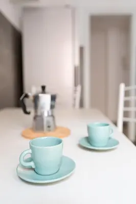 two blue cups and saucers sitting on a table at Macedonia 30 Bright Flat in Rome