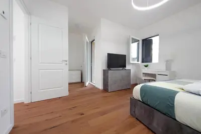 a bedroom with a bed and a desk and a television at Sabelli 1 Villa Indipendente nel Cuore di Roma in Rome