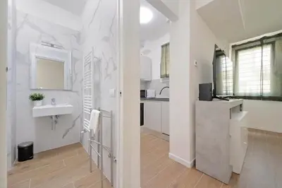 a white bathroom with a sink and a counter at Sabelli 1 Villa Indipendente nel Cuore di Roma in Rome