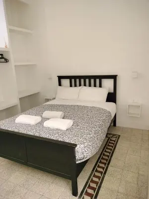 a bedroom with a bed with two towels on it at Vatican room - all you need to sleep 1 in Rome