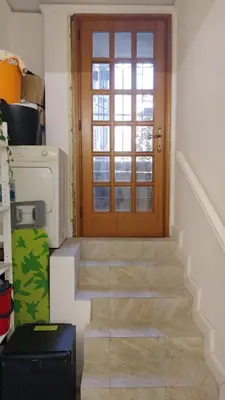 a stairway with a wooden door and a window at Vatican room - all you need to sleep 1 in Rome