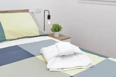 a bedroom with a bed with towels on it at Sabelli 2 Villa Indipendente nel Cuore di Roma in Rome