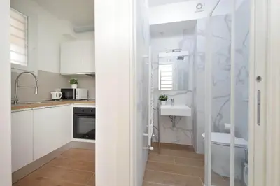 a small kitchen with white cabinets and a sink at Sabelli 2 Villa Indipendente nel Cuore di Roma in Rome