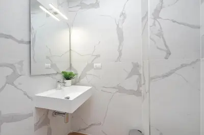 a white bathroom with a sink and a shower at Sabelli 3 Villa Indipendente con Studio Privato in Rome