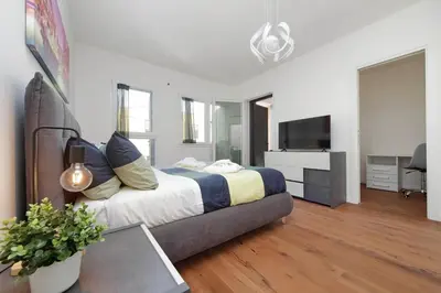 a bedroom with a bed and a flat screen tv at Sabelli 3 Villa Indipendente con Studio Privato in Rome