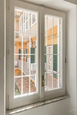 a window with a view of a house at La Dolce Vita - Elegant retreat in the heart of Rome in Rome