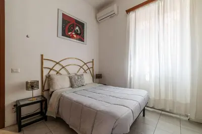 a bedroom with a bed and a window at GuestHost - Comfy Apartment X2 in Monteverde in Rome