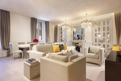 a living room with white furniture and a dining room at Saphir Luxury Apartment in Rome