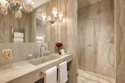 a bathroom with a shower and a sink and a mirror at Saphir Luxury Apartment in Rome
