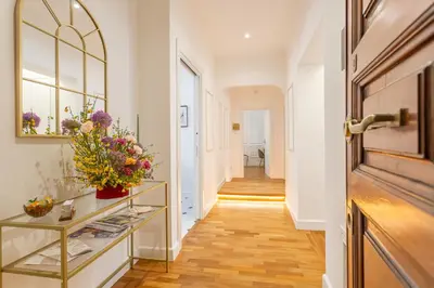 a hallway with a vase of flowers on a shelf at Blue Prestige Suites in Rome