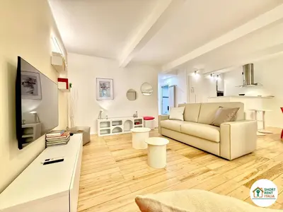 a living room with a couch and a television at Colosseo - Venus House in Rome