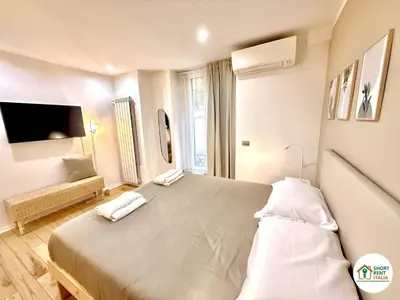 a bedroom with a large bed and a tv at Colosseo - Venus House in Rome