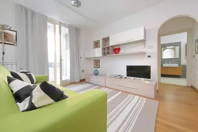 a living room with a green couch and a television at 4BNB - Porta Portese Cozy Apartment in Rome