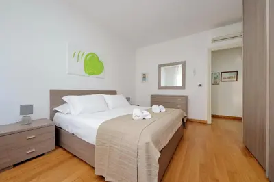 a bedroom with a large bed with two towels on it at 4BNB - Porta Portese Cozy Apartment in Rome