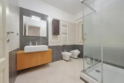 a bathroom with a sink and a toilet and a shower at 4BNB - Porta Portese Cozy Apartment in Rome