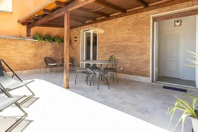 an outdoor patio with a table and chairs at Constance Terrace Apartment by Rental in Rome in Rome