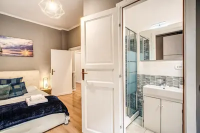 a bedroom with a bed and a bathroom at Large Apartment in San Giovanni A in Rome