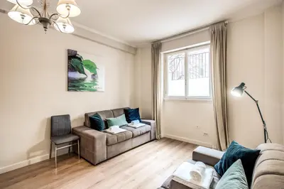 a living room with a couch and a chair at Large Apartment in San Giovanni A in Rome