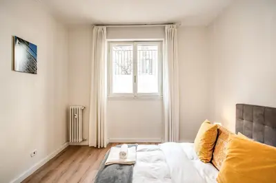 a bedroom with a bed and a window at Large Apartment in San Giovanni A in Rome