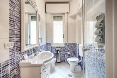a bathroom with a white sink and a toilet at Large Apartment in San Giovanni A in Rome