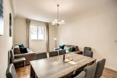 a dining room with a large wooden table and chairs at Large Apartment in San Giovanni A in Rome